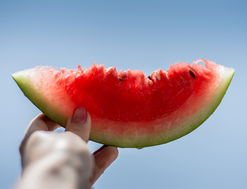 A food photography picture of a watermelon held up the light