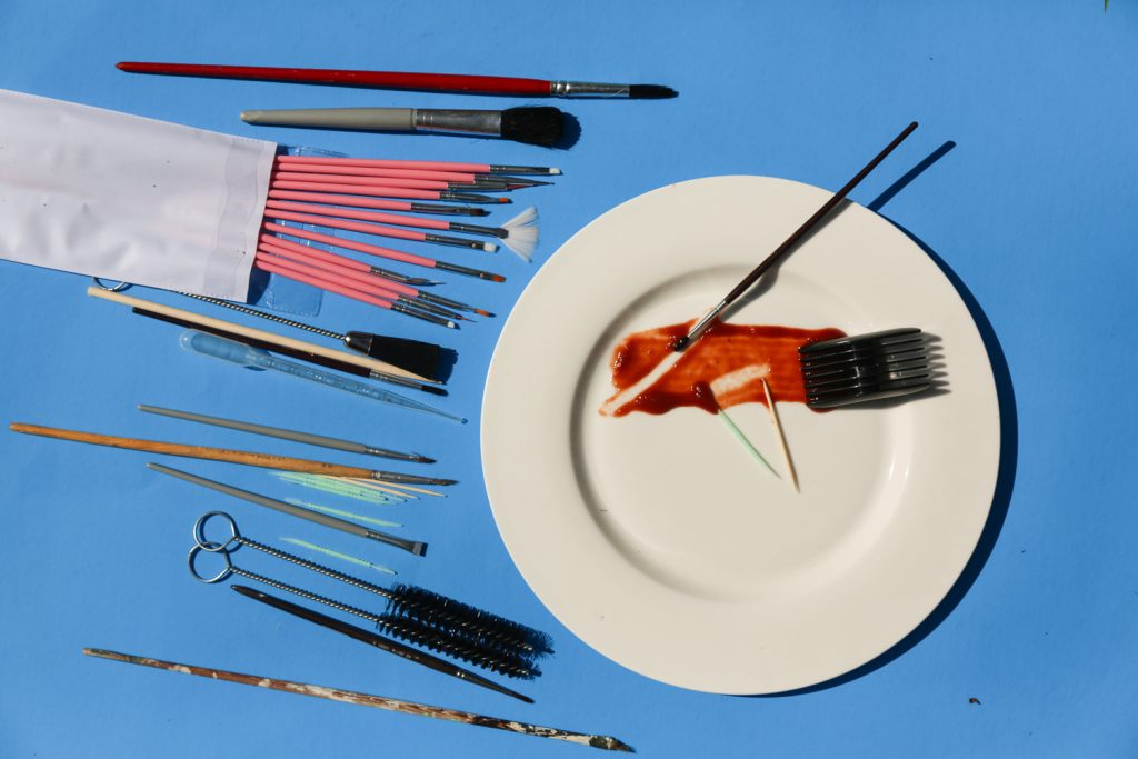 Brushes and toothpicks are among the equipment used by a professional food stylist for touch-up work