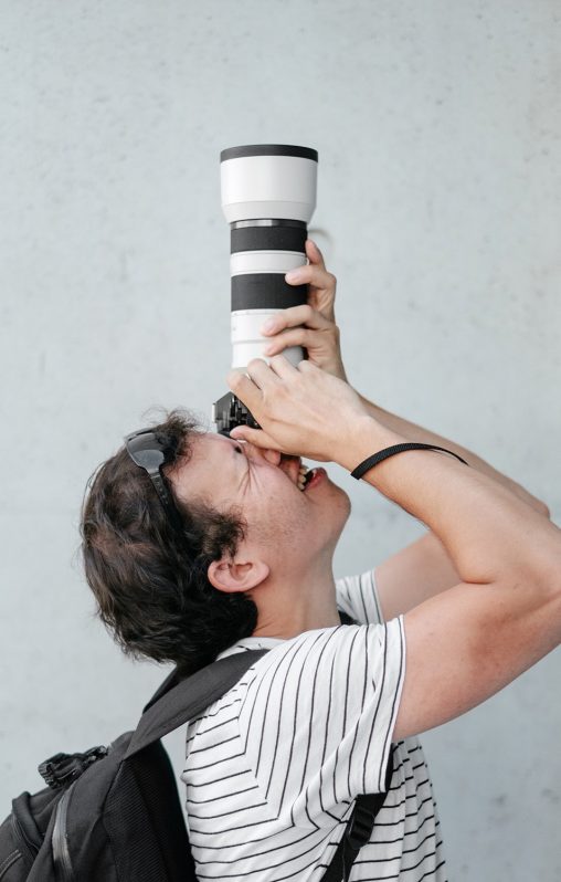 A man with a long zoom lens